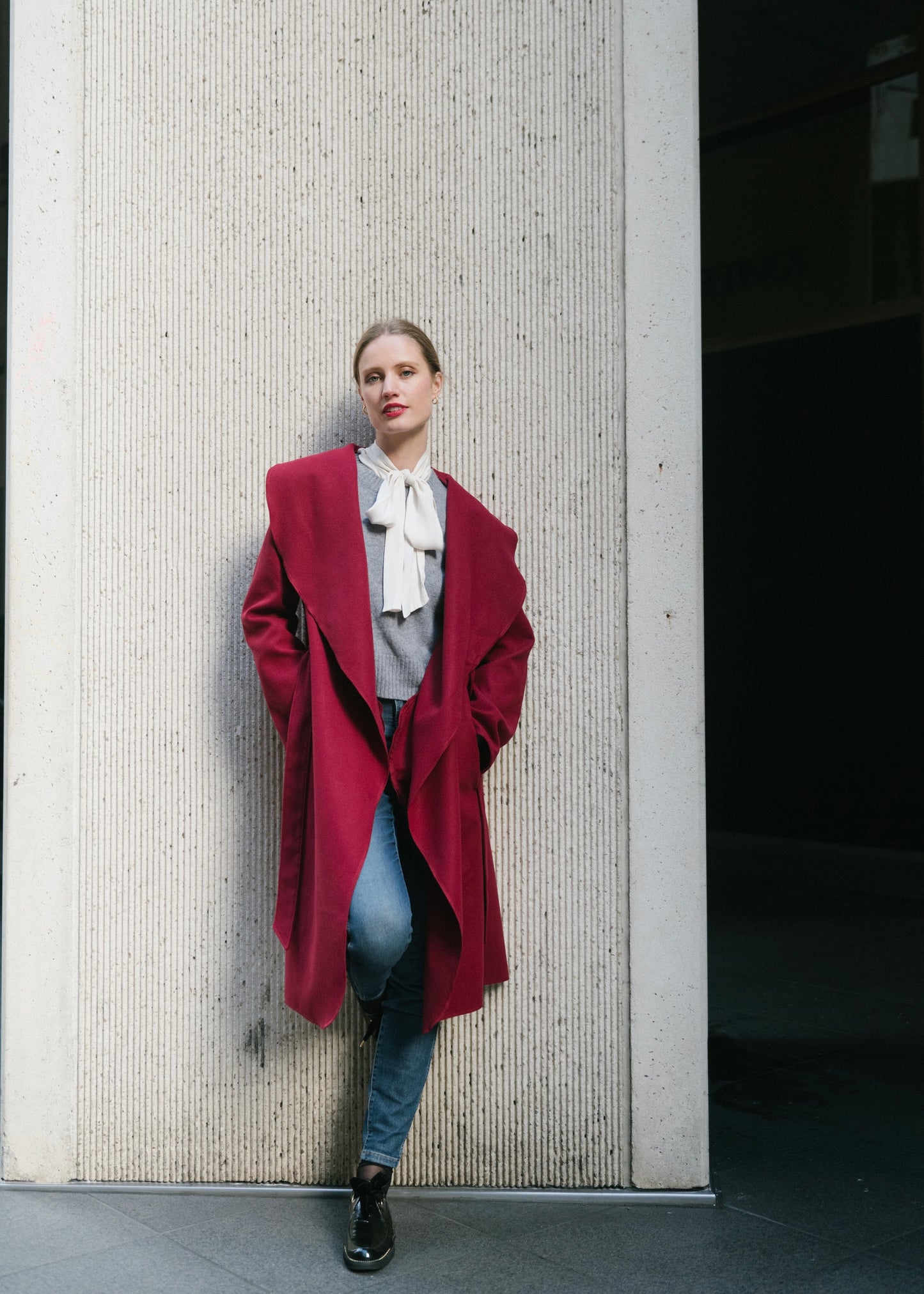 Close-up of wool blend fabric and hand-stitched details on Vino wrap coat