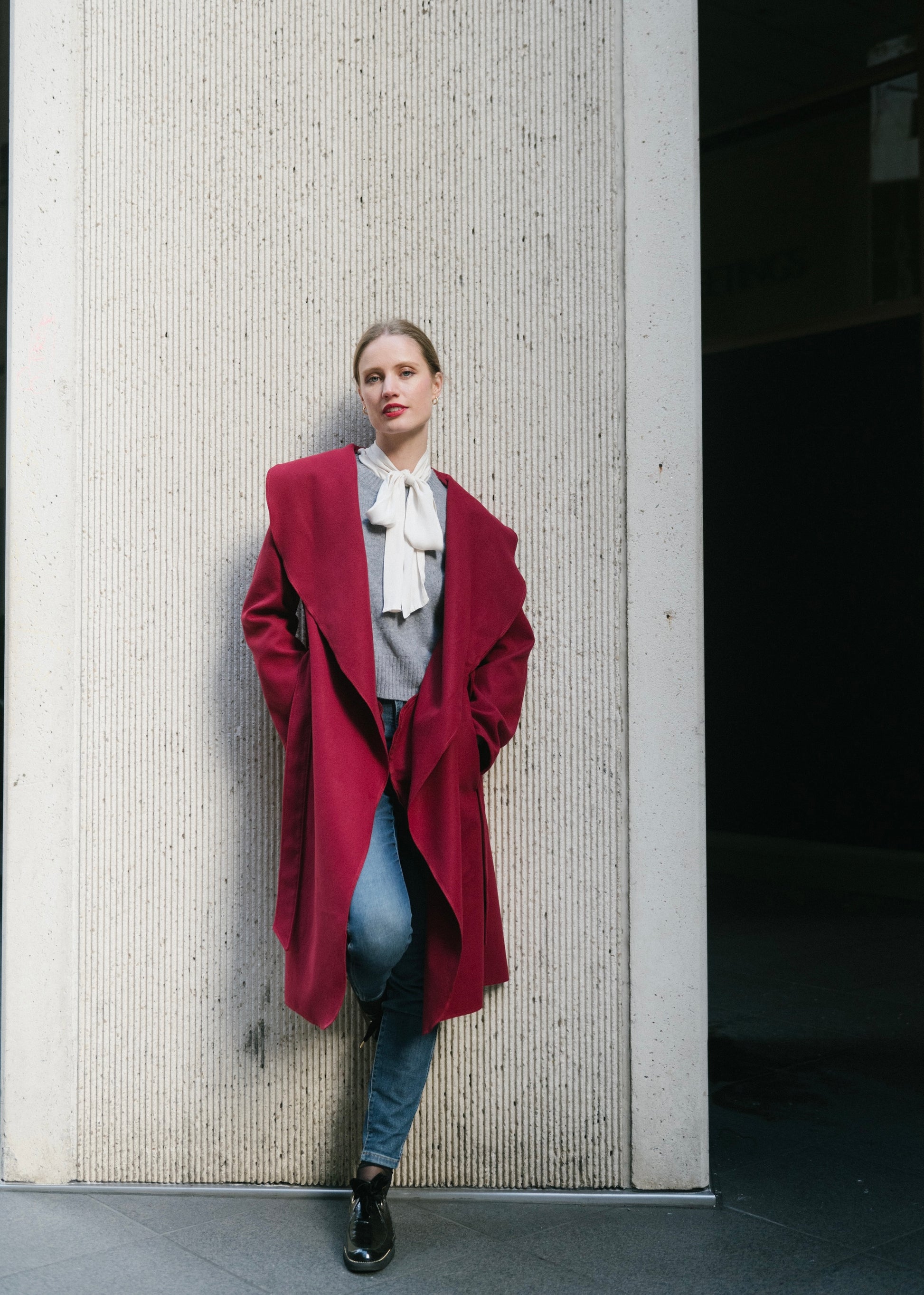 Close-up of wool blend fabric and hand-stitched details on Vino wrap coat