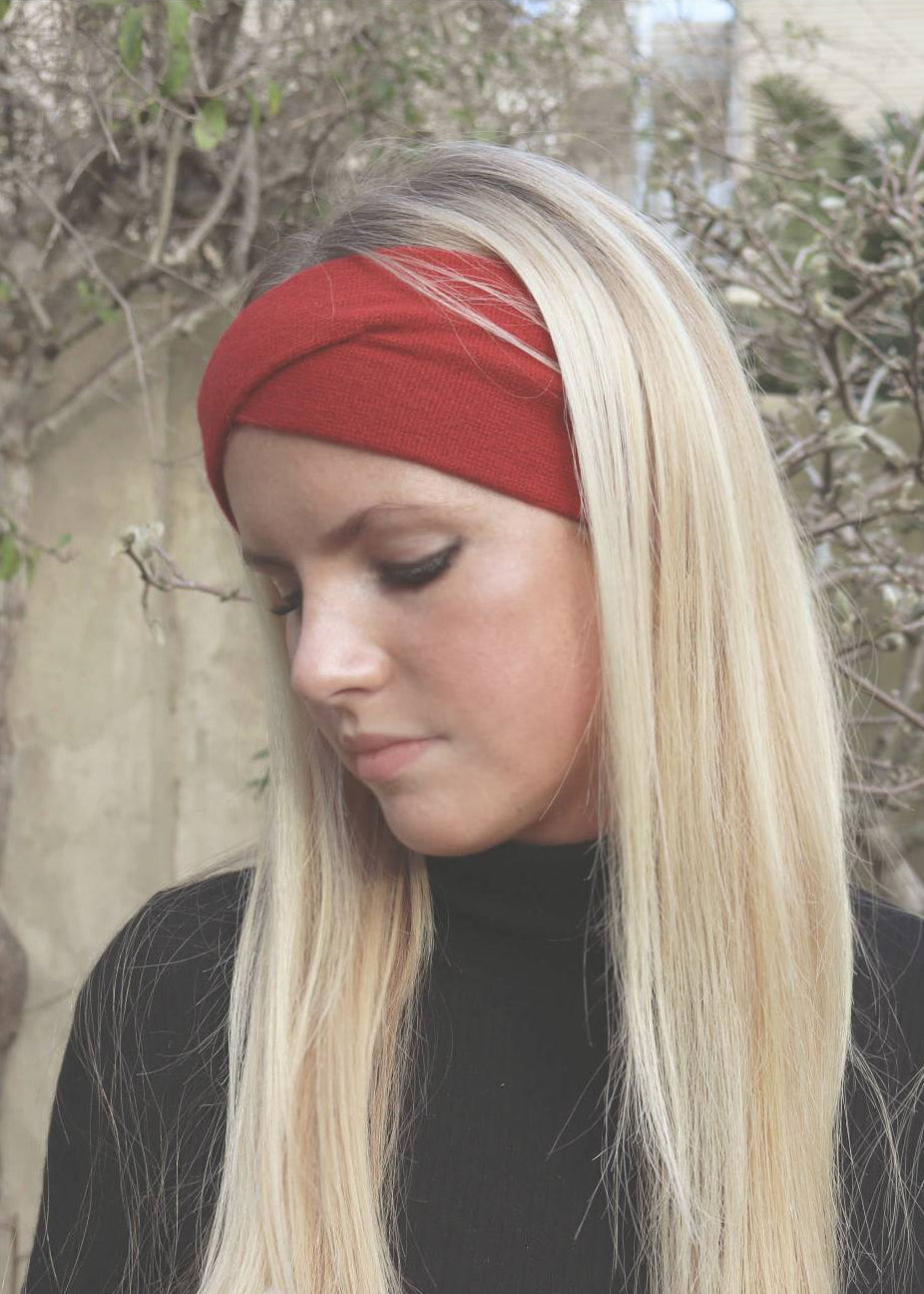blonde woman wearing a red headband and black turtleneck